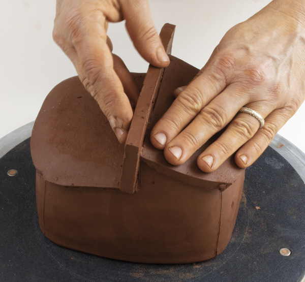 Example of using hands as a tool in forming clay.