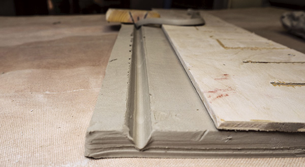 6 Use the double-bevel cutter to create a hinge in the slab. Your template can aid in helping to create a straight cut.