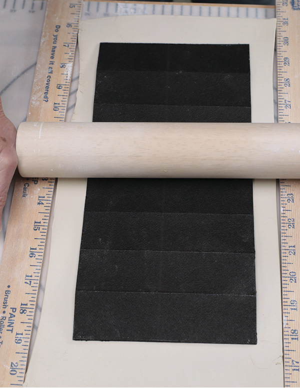 7 Roll the template onto the slab. Cut around it and remove the excess clay.