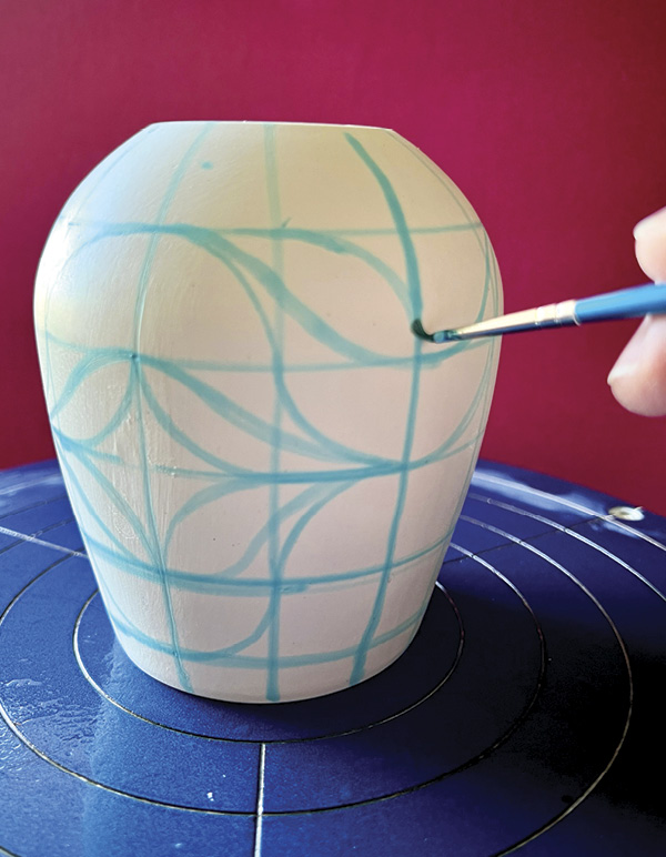 4 Paint the design over the grid on the pot with food coloring and a fine brush.