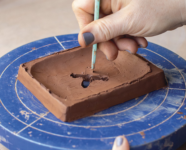 3 Mark then cut out an X shape in the middle of the dish form.