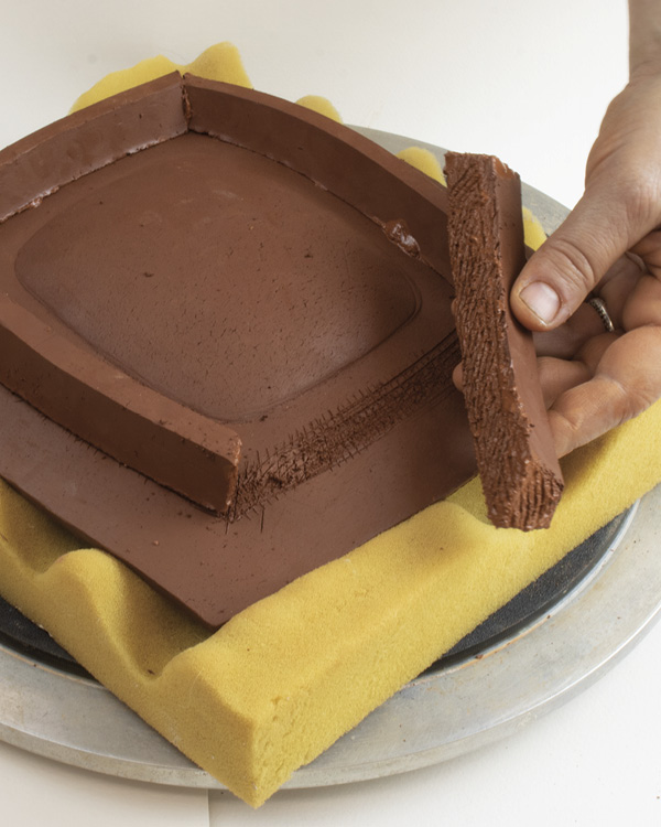 10 Once stiffened up a bit, flip the tray over and add slab strips to create a foot.