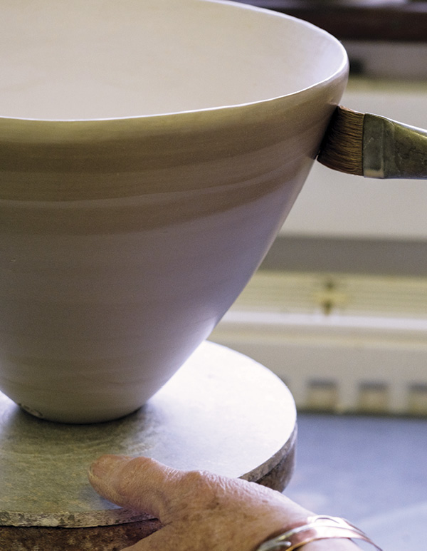 6 Brush terra sigillata onto the surface of the pot.