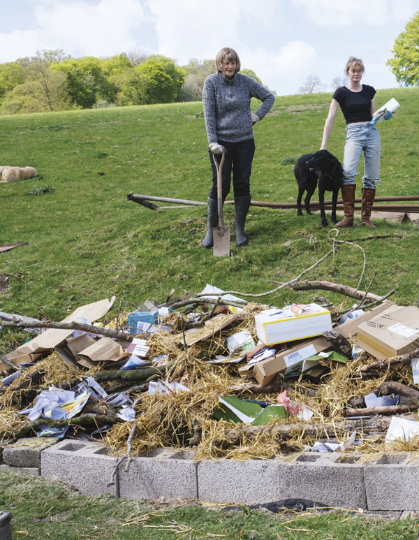 12 Cover the wood with straw, cardboard, and waste paper before lighting the fire.