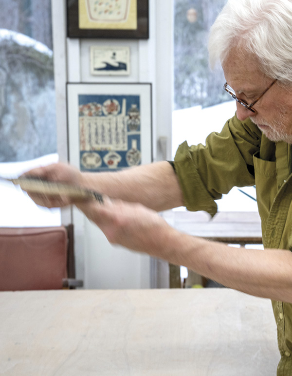 6 Begin to stretch the clay, by throwing the slab at a slight angle against your table.