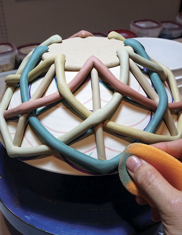 11 Score and attach the final connection, with the colored coils on the outside.