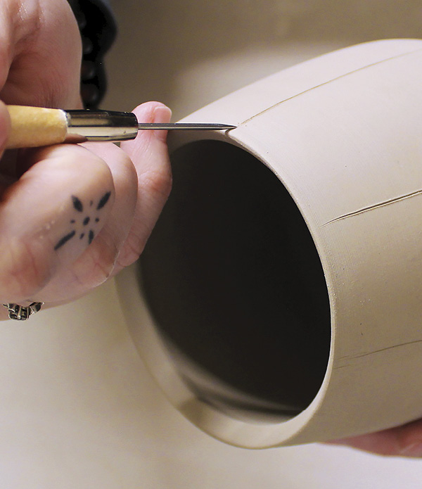 2 Use a needle tool to carve guidelines on the surface.