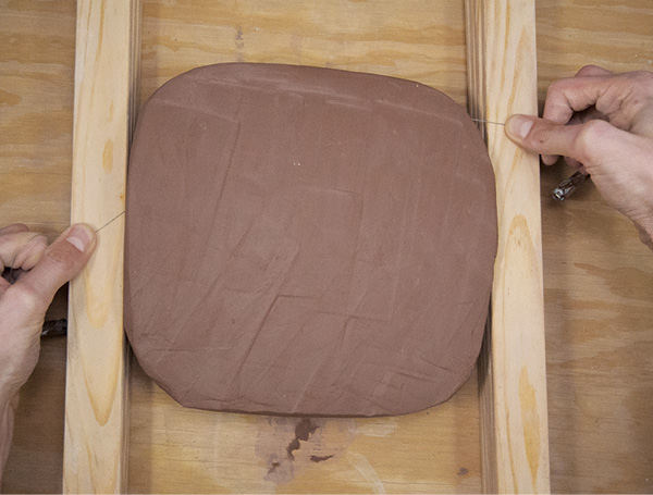 1 Use a wooden mallet to pound a block of clay into a slab large enough to fit the template. Wire cut through the block against wooden strips. After each cut, remove a strip from each side.