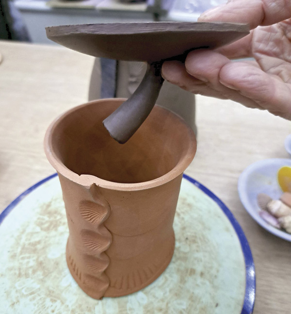 1 Use a chuck to preserve the top and knob of lids while working on the underside.