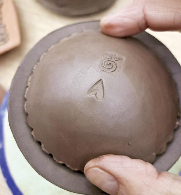7 Gently press opposite edges of the dome to attach without denting or shifting.