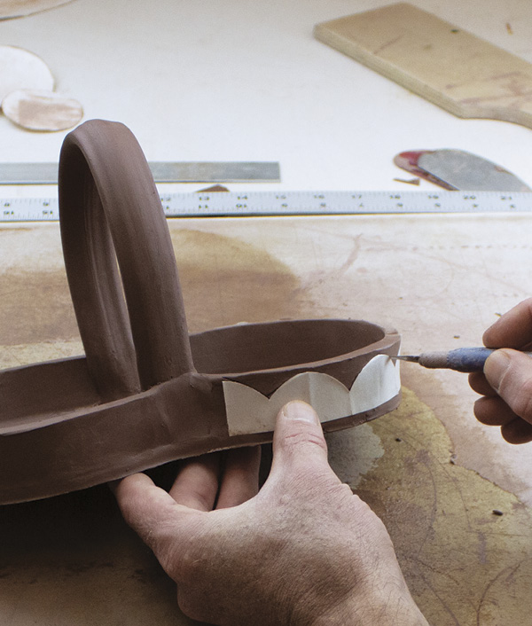 10 Cut the scalloped edges of the tray using a newsprint paper template and a knife. Compress and soften the cut scallops.