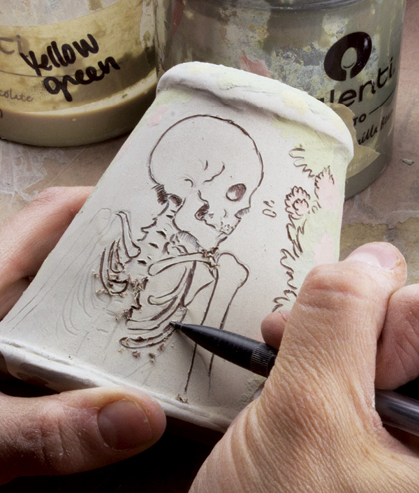 14 Using a mechanical pencil, or a similar tipped tool, gently carve into the slip and expose the red clay underneath.