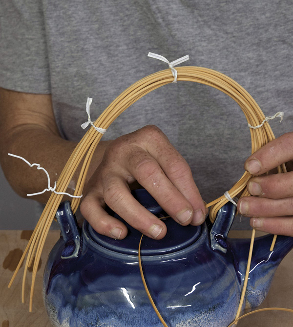 3 Use white twist ties to bind all strands of the handle tightly together from one lug to the other.