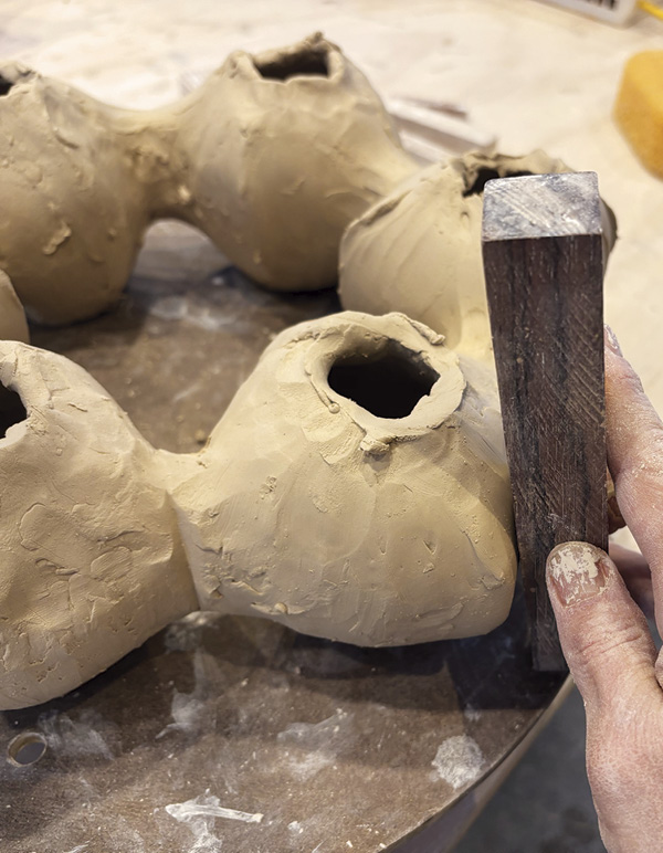 8 Use a wooden block to smooth walls and define creases.