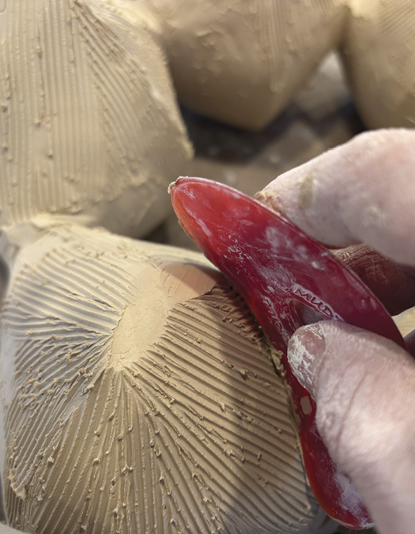 12 Smooth out serrated tooth marks with a red rubber rib.