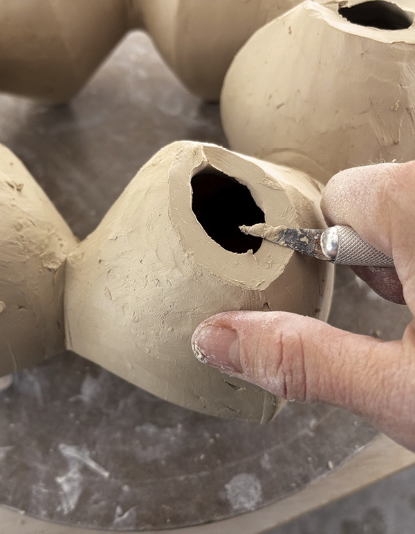 13 Once smooth, use knife to trim and level the top rims for attachments.