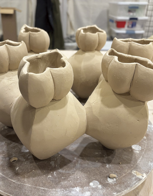 17 Slip, score, and attach openings to each lobe of the ring. Refine each rim.