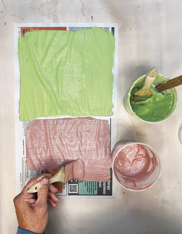 1 Brush on the&nbsp;slip, obscuring the newsprint text. Allow to dry overnight.