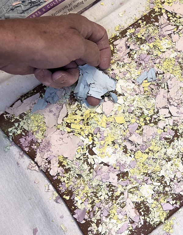 3 Pull dried slips from newsprint to layer on a fresh slab.