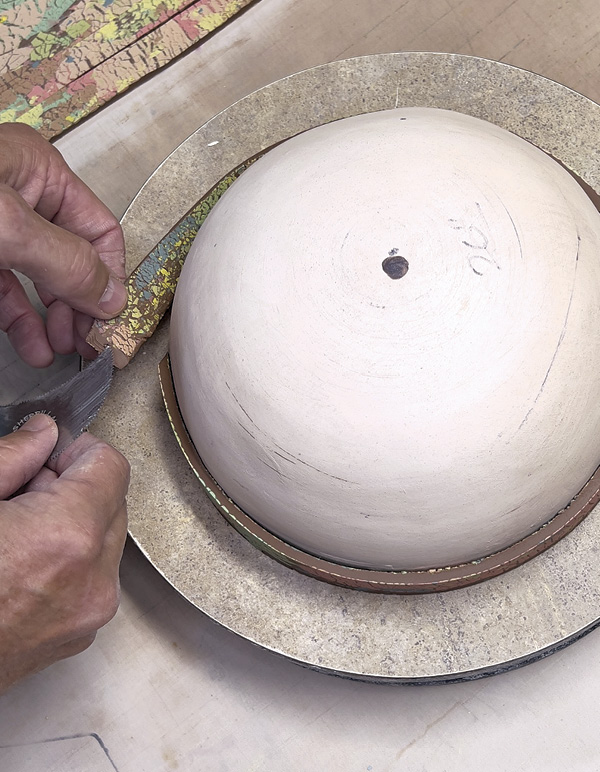 9 Apply the first strip at the mold base. Score and add vinegar to attach strips.