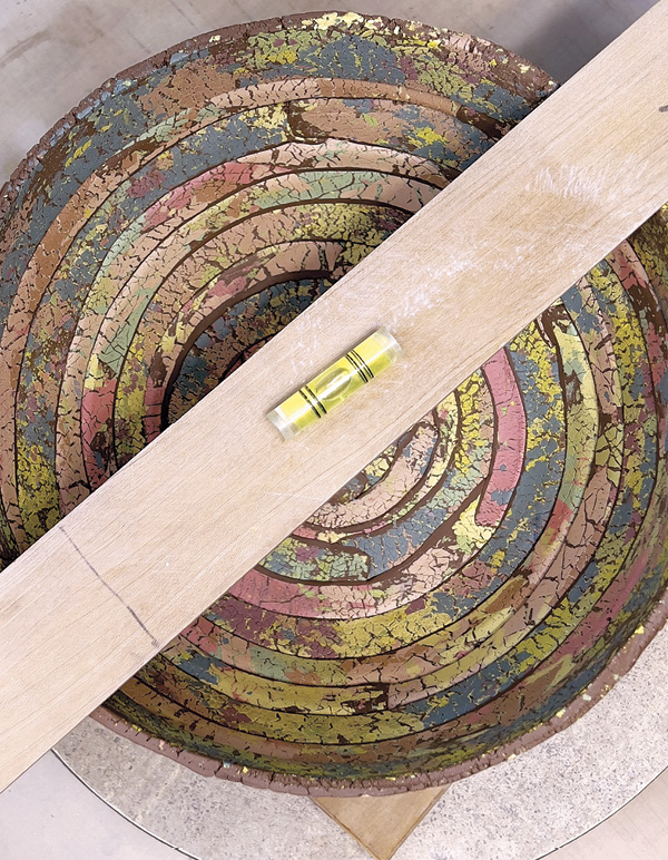 14 Check that the interior is slightly flattened. Check the rim with a level.