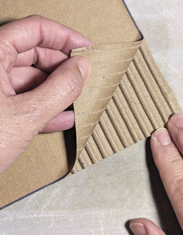 4 Reveal the flutes or ribs by peeling back top layer of the cardboard sheet.