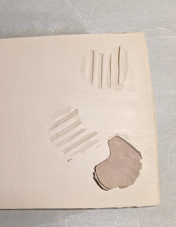 9 Example of making a clay stamp using a small bit of separated cardboard.