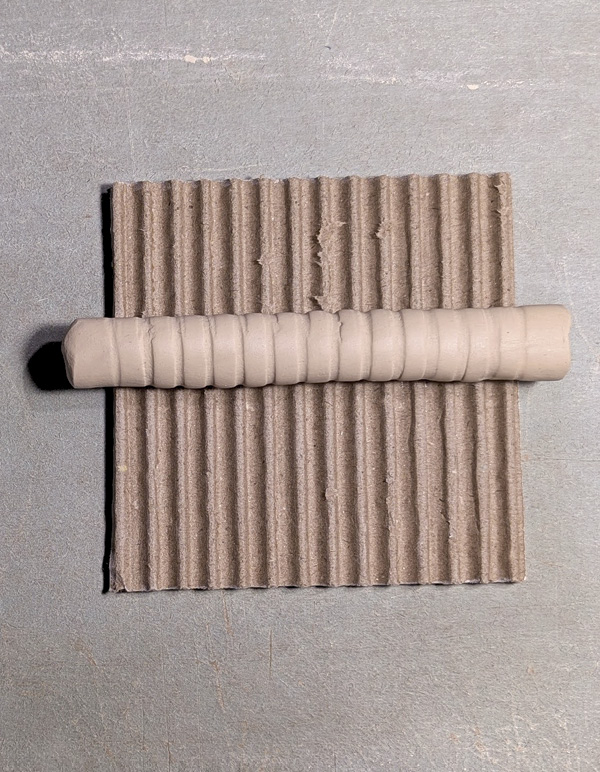 12 Make textured rollers using a small piece of cardboard and rolled clay coil.