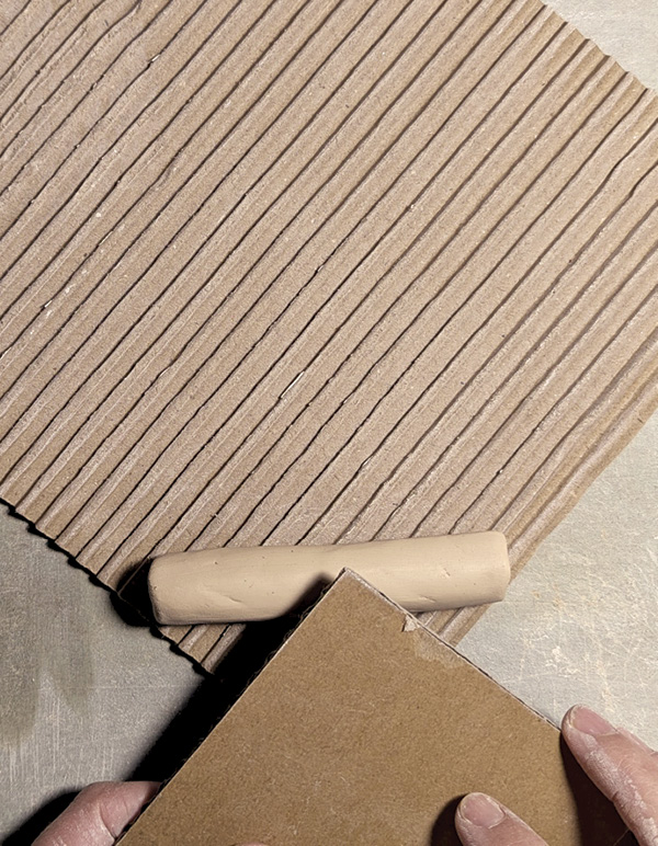 13 Sandwich a coil between two pieces of cardboard to make a checked roller.