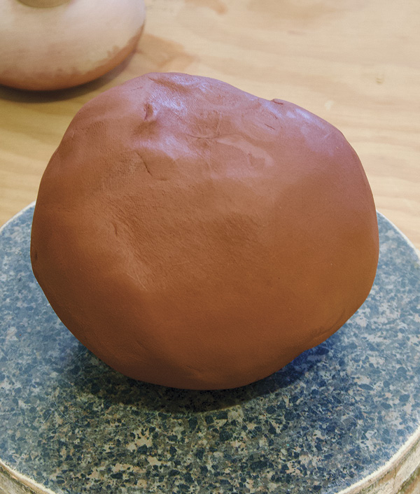 2 Wedge 3 pounds (1.36 kg) of clay then pat it into a ball shape.