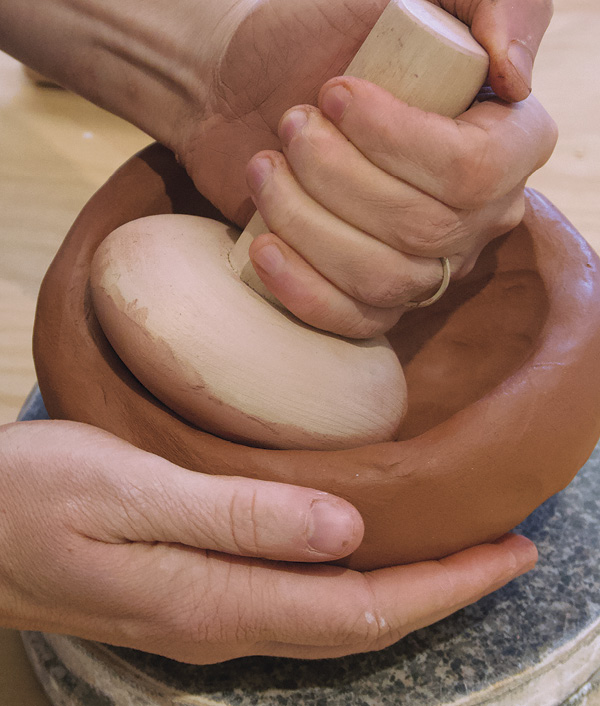 4 Use a paddle (or sock full of sand) to compress the bowl’s interior.