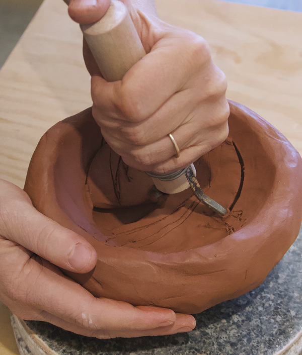 6 Carve out the inside with a wide loop tool in a steady, continual drag.