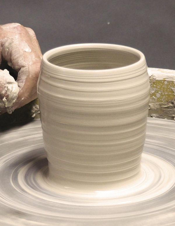 1 Center a ball of clay. Raise the walls into a cylinder.