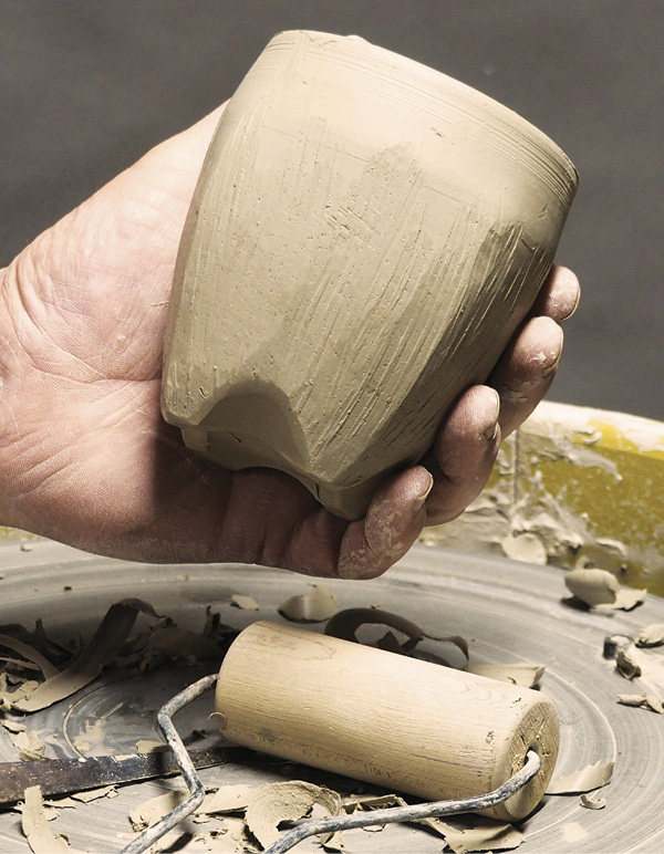 14 Use a pony roller or dowel to compress the curve and refine the footed form.