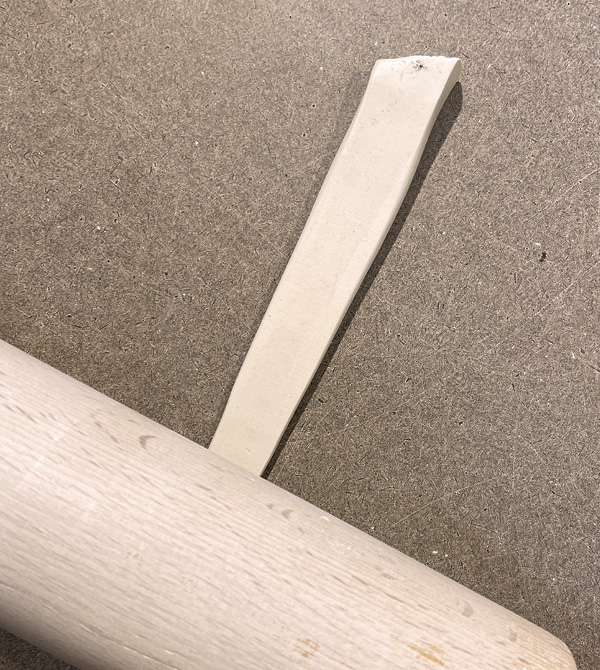 A1 Cut a long, tapering triangular piece from a rolled and compressed slab.