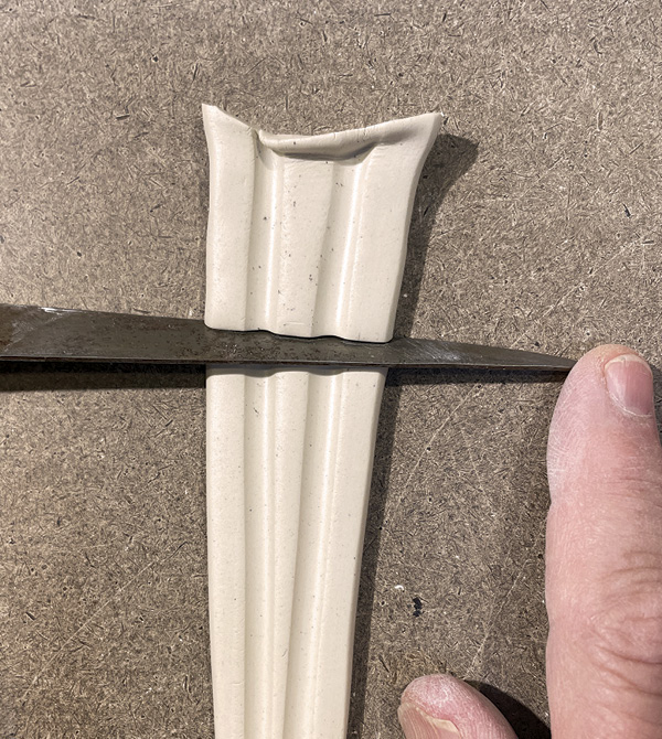 A4 Use a long-bladed fettling knife tipped at a 45° angle to cut the triangle.