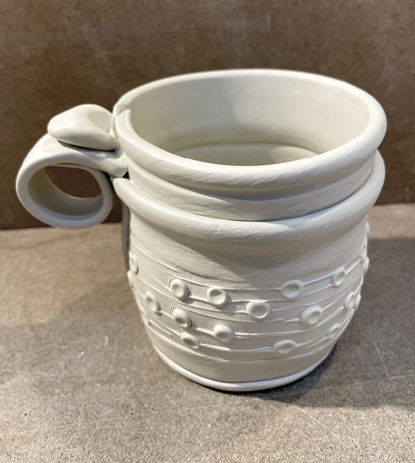 B5 Score and slip the thumb rest and add it on top of the circular piece.