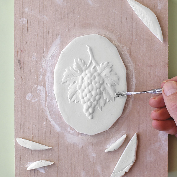 5 Trim the slab with a fettling knife and refine the relief with modeling tools.