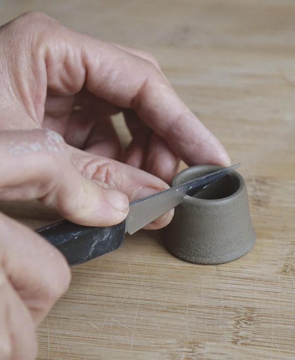 7 Using a sharp knife, cut the spout in half lengthwise, then set the pieces aside wrapped in plastic.