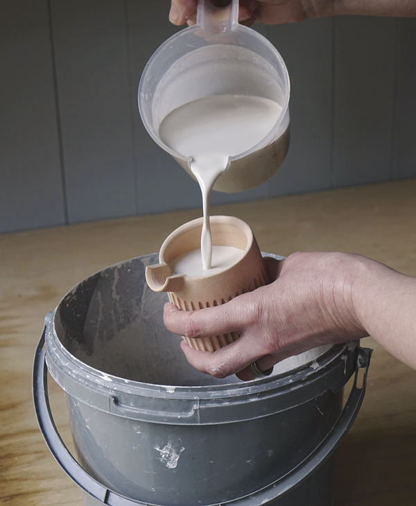 14 Rinse and lightly sand the bisque-fired piece. Wax the base to repel glaze, then coat the interior with a liner glaze.