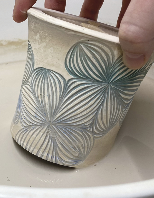 12 Coat the exterior in clear glaze, then swirl the rim at an angle to coat the inner lip.