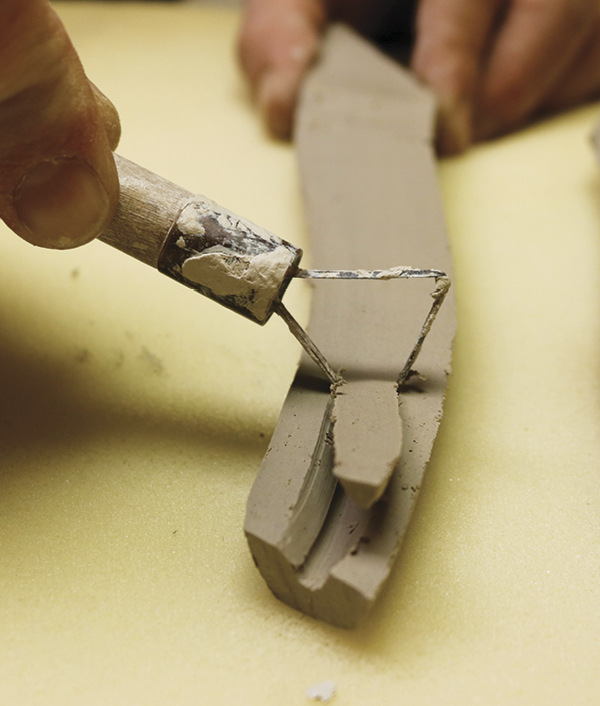 8 Cut the spout in half. Using a trimming tool, hollow the spout leaving  inch along either side of the wall.