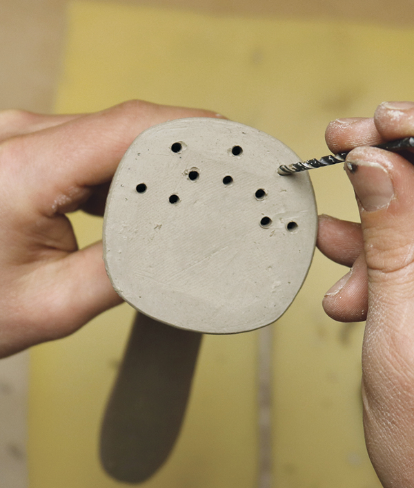 12 Map out the holes on the face of the bell, then gently drill them with an ⅛-inch drill bit.