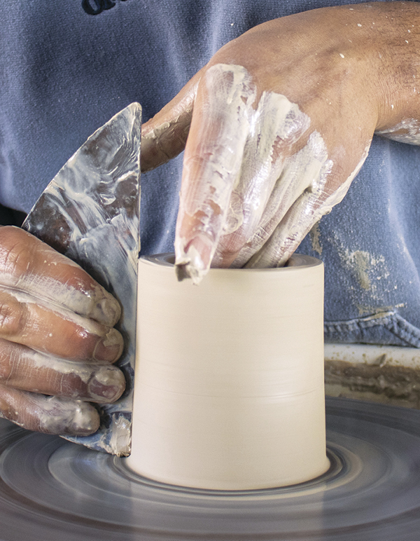 5 Throw a narrow cup with ½-inch-thick walls. Straighten the sides of the form.