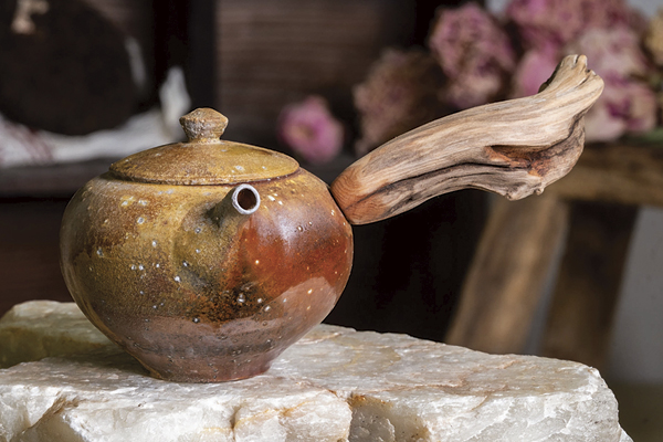 A freshly finished kyusu with a found-wood handle, ready for its first brew of fine tea.