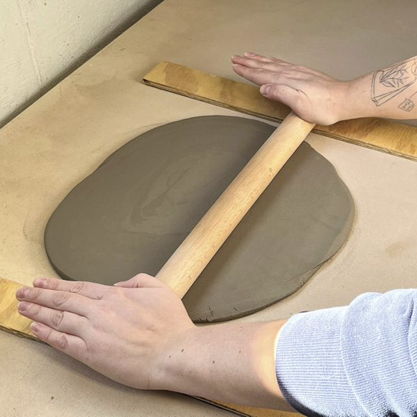 1 Roll out a slab large enough to cut a 14-inch (35.6-cm) diameter circle.