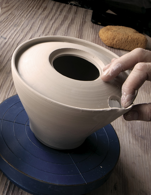 5 Cut a hole in the shoulder and pull out a spout throat and lip.