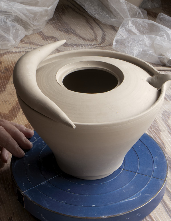 6 Attach the first tapered coil to the rim of the shoulder.