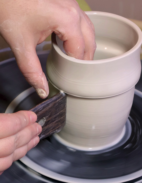 4 Hold a wooden rib on the marked line and push the clay to create a flange.