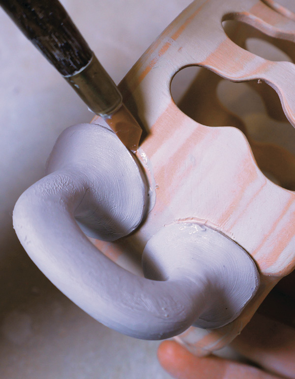 11 Refine the handle attachment points with a rubber-tipped tool.